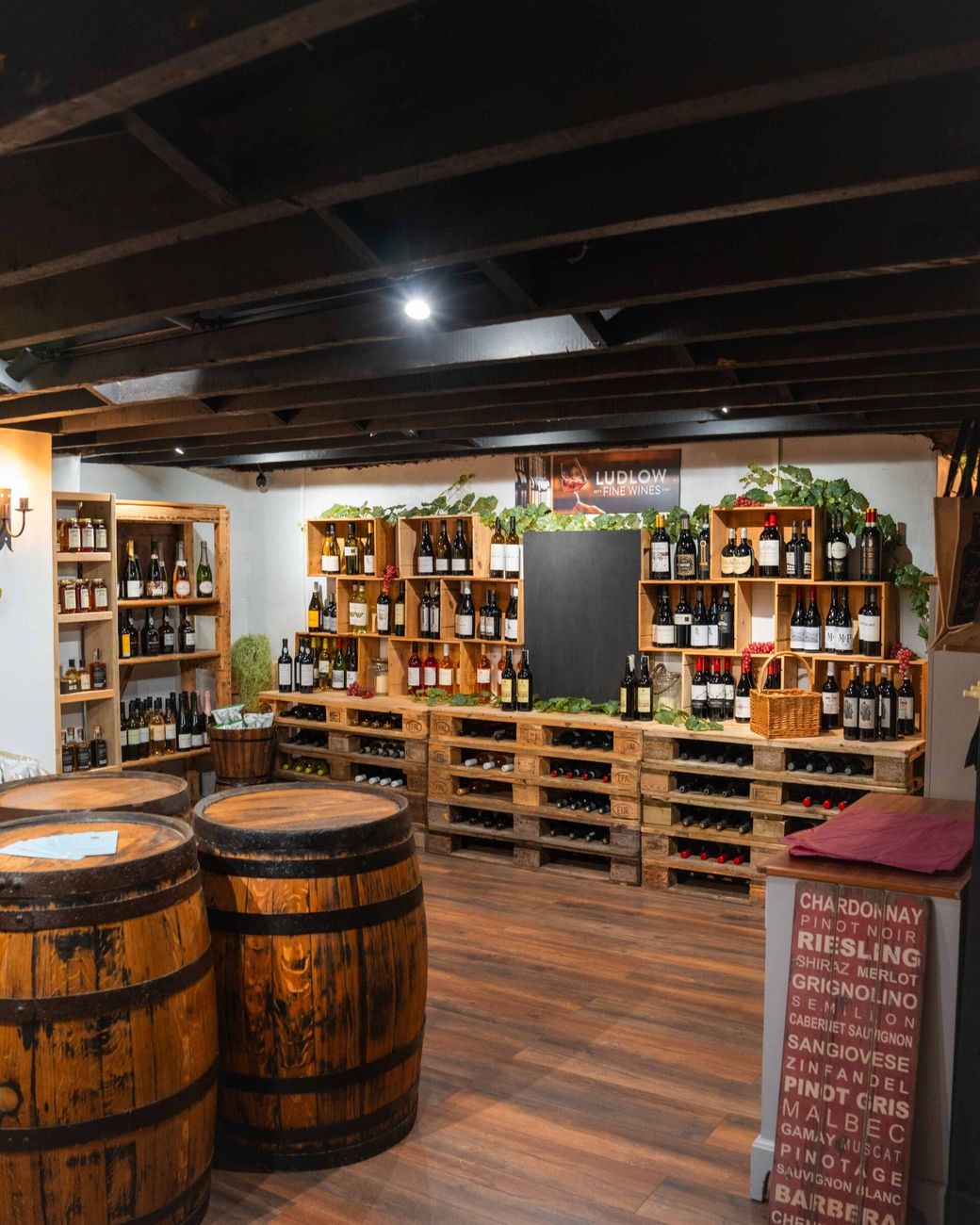 The wine cellar at Truffles, with oak crate racks, barrel tables and a varietal banner